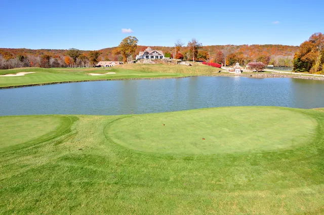 a front view of a house with a yard and potted plants