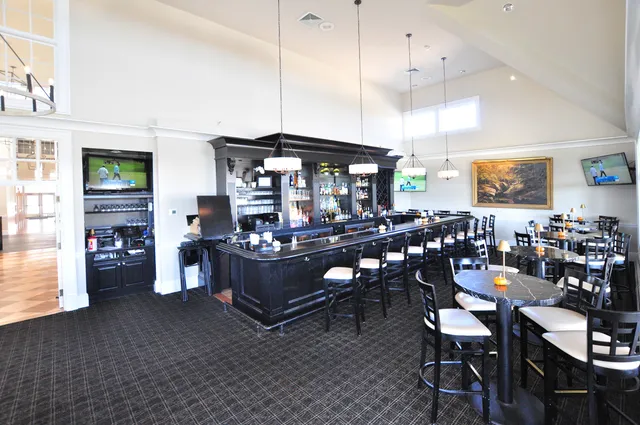 a living room with furniture a fireplace and large windows
