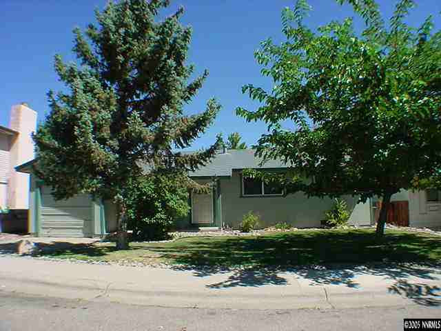 3470 Yosemite Place Reno, NV 89503 - Photo 1 of 1 a front view of a house with a garden and tree