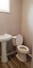 a white toilet sitting next to a white sink