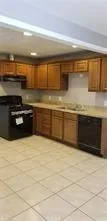 a kitchen with stainless steel appliances granite countertop a sink and a stove