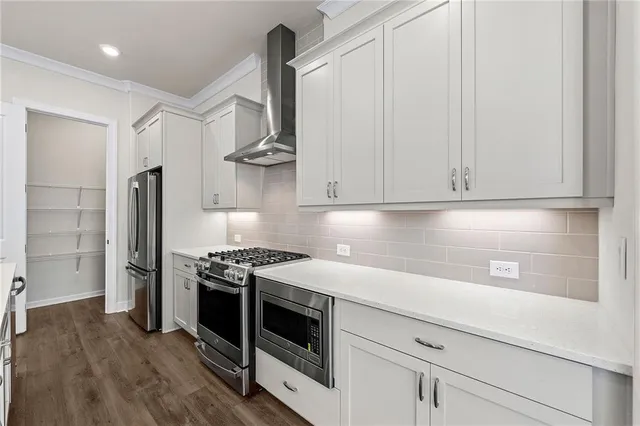 a kitchen with stainless steel appliances a stove and a refrigerator