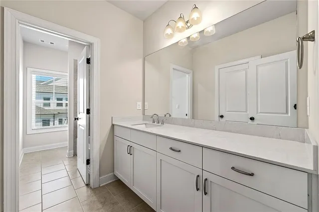 a view of a double vanity sink mirror and cabinets