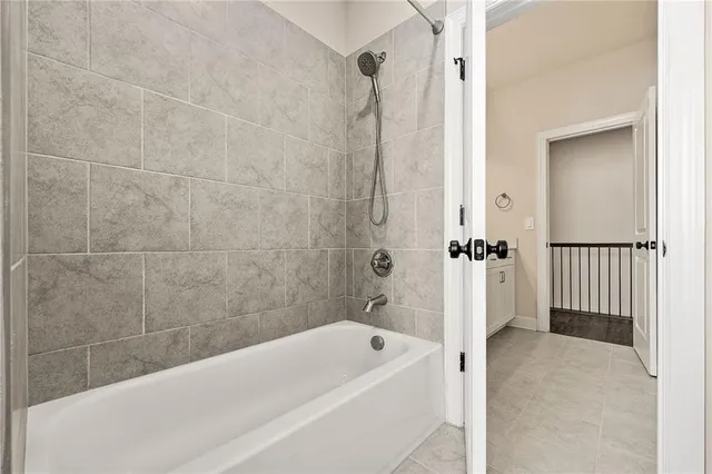 a bathroom with a bathtub and a shower