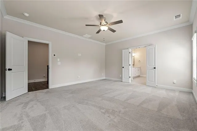 a view of an empty room with a ceiling fan