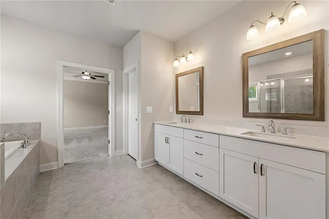 a spacious bathroom with double sink and a mirror