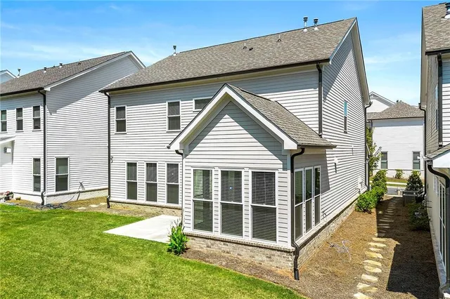 a view of a house with yard and wooden fence