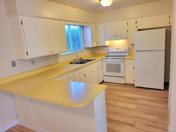 a kitchen with wooden cabinets and a sink
