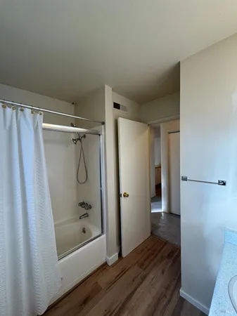 an empty room with a window and a ceiling fan