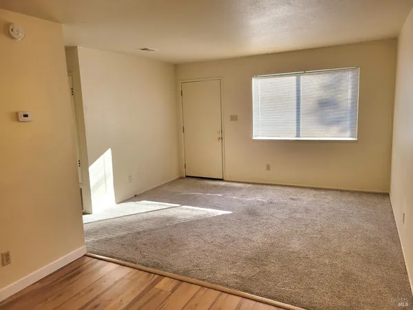 a kitchen with stainless steel appliances granite countertop a white cabinets and wooden floor