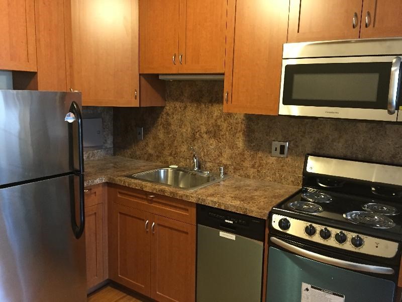 200 Swanton Street, Unit 238 Winchester, MA 01890 - Photo 2 of 7 a kitchen with a sink and stainless steel appliances
