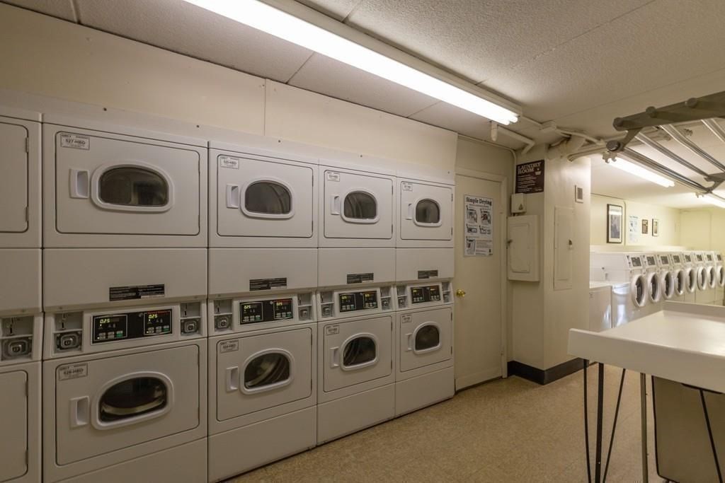 200 Swanton Street, Unit 238 Winchester, MA 01890 - Photo 7 of 7 a utility room with stainless steel appliances wooden floor and a large window