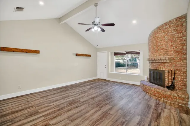 wooden floor in an empty room with a fireplace