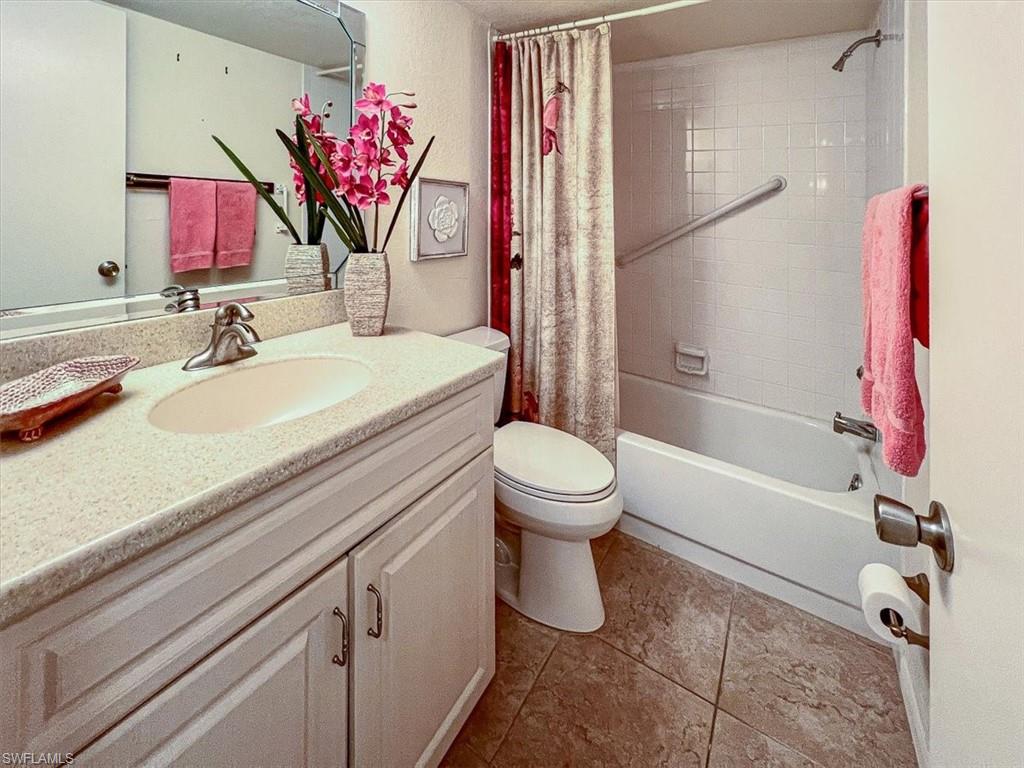 5515 Rattlesnake Hamm Road, Unit 301 Naples, FL 34113 - Photo 12 of 30 a bathroom with a sink a vanity and a mirror