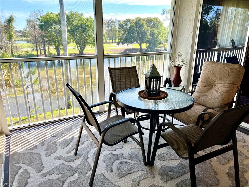 5515 Rattlesnake Hamm Road, Unit 301 Naples, FL 34113 - Photo 13 of 30 a view of a dining room with furniture window and wooden floor