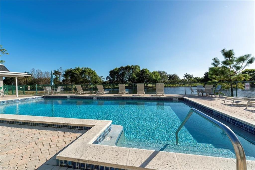 5515 Rattlesnake Hamm Road, Unit 301 Naples, FL 34113 - Photo 18 of 30 a view of a swimming pool with a yard