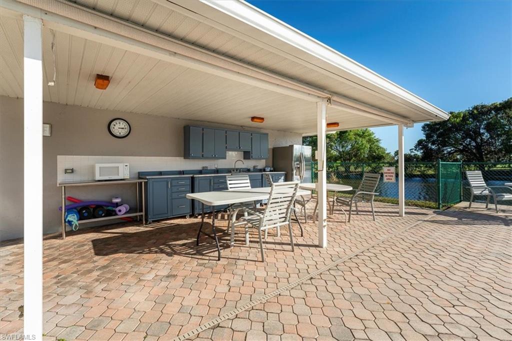 5515 Rattlesnake Hamm Road, Unit 301 Naples, FL 34113 - Photo 19 of 30 a view of living room with a table and chairs