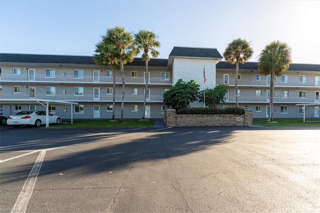 5515 Rattlesnake Hamm Road, Unit 301 Naples, FL 34113 - Photo 26 of 30 a view of a building with a yard