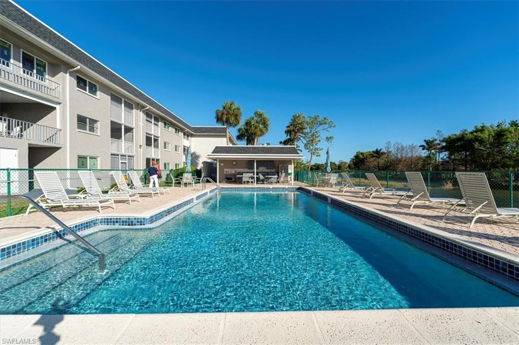 5515 Rattlesnake Hamm Road, Unit 301 Naples, FL 34113 - Photo 4 of 30 a view of swimming pool with a yard