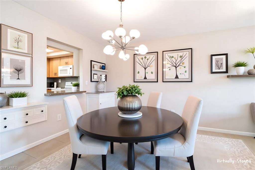 5515 Rattlesnake Hamm Road, Unit 301 Naples, FL 34113 - Photo 6 of 30 a view of a dining room with furniture and chandelier