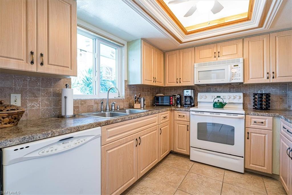 5515 Rattlesnake Hamm Road, Unit 301 Naples, FL 34113 - Photo 8 of 30 a kitchen with stainless steel appliances granite countertop a sink and cabinets