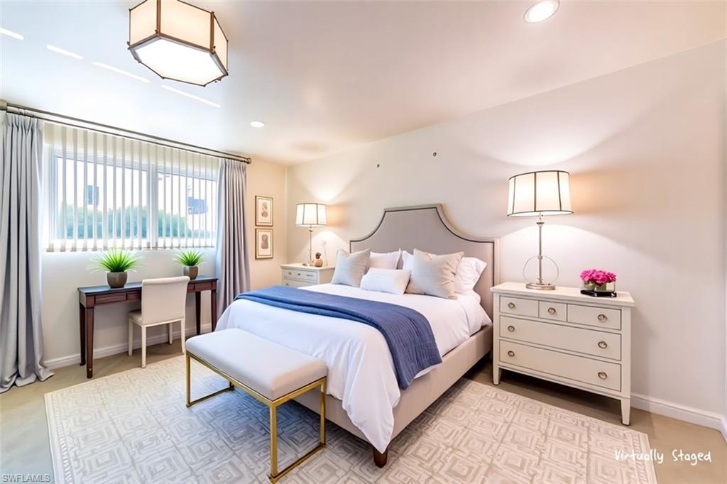 5515 Rattlesnake Hamm Road, Unit 301 Naples, FL 34113 - Photo 9 of 30 a bedroom with a bed and a table