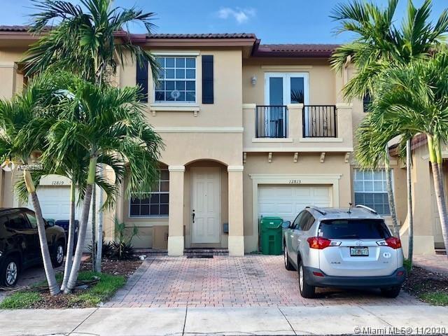12813 Southwest 132nd Terrace Miami, FL 33186 - Photo 1 of 8 a house view with a sitting space and garden