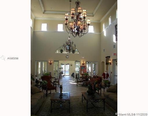 12813 Southwest 132nd Terrace Miami, FL 33186 - Photo 6 of 8 a view of a dining room with furniture and chandelier