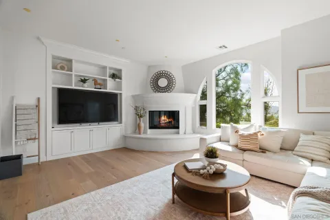 a living room with furniture a flat screen tv and a large window