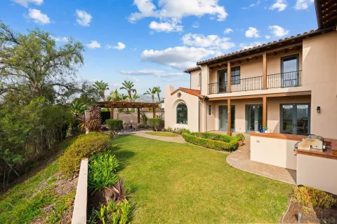a front view of a house with a yard table and chairs