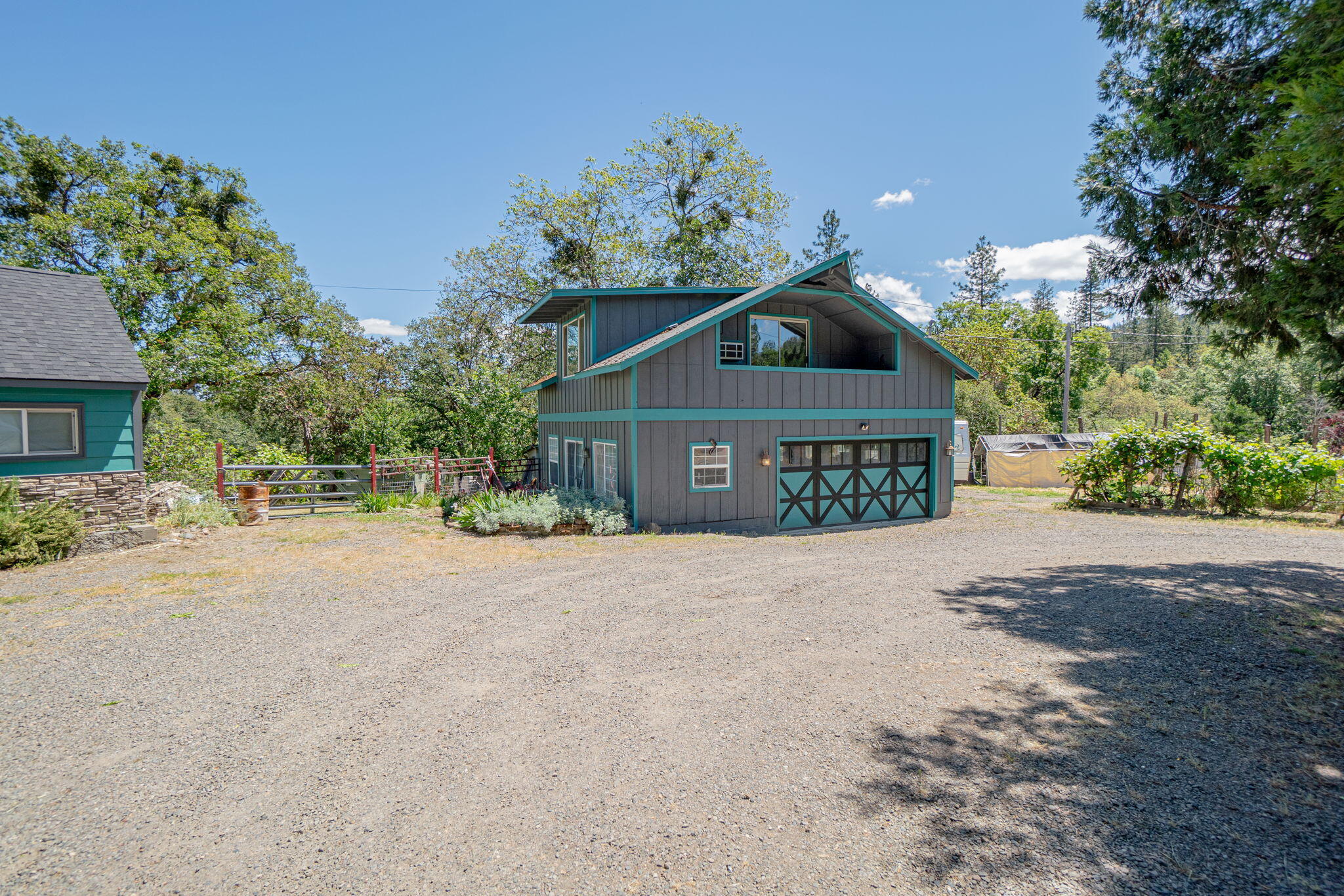 4970 Old Stage Road Central Point, OR 97502 - Photo 32 of 43 a front view of a house with a yard and garage