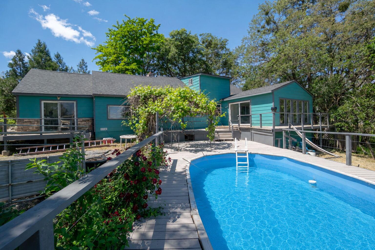 4970 Old Stage Road Central Point, OR 97502 - Photo 39 of 43 a view of a house with backyard sitting area and garden