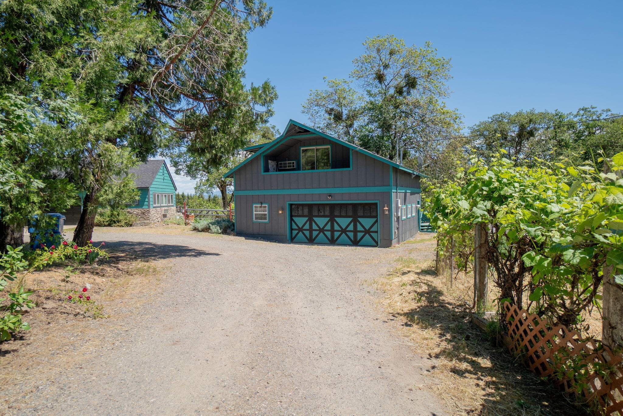 4970 Old Stage Road Central Point, OR 97502 - Photo 4 of 43 a front view of a house with a yard and garage