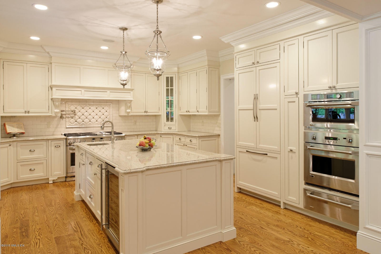 25 Cutler Road Greenwich, CT 06831 - Photo 7 of 40 a kitchen with kitchen island white cabinets and white appliances