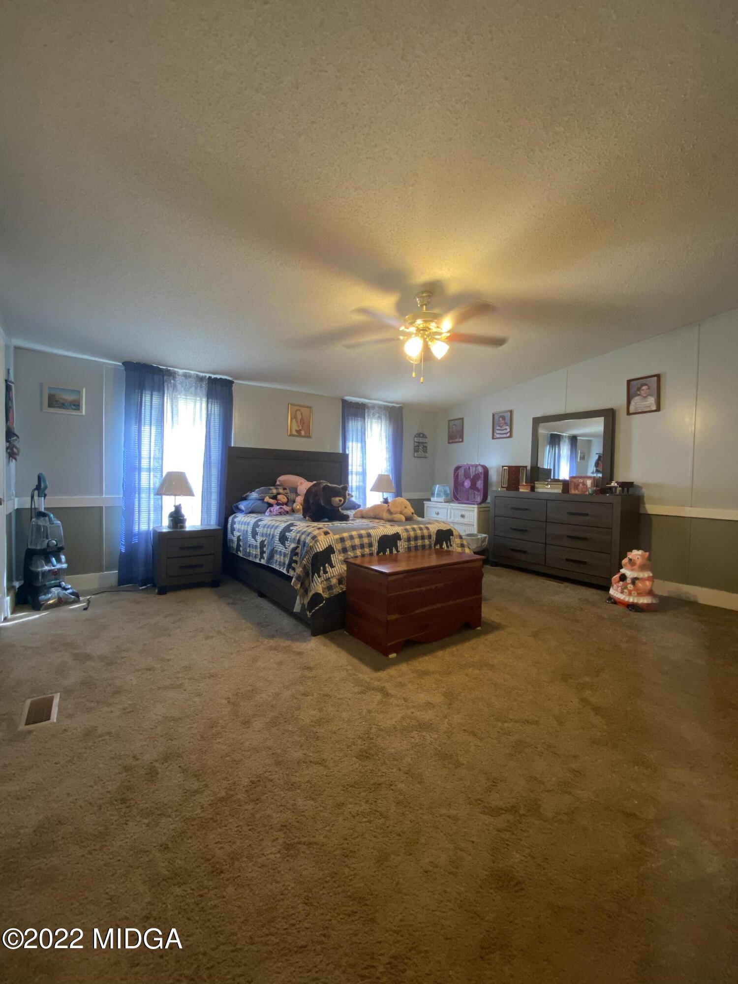 28 Little Collier Road Forsyth, GA 31029 - Photo 3 of 19 a bed room with furniture and a lamp