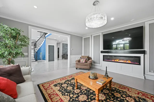 a living room with furniture and a chandelier