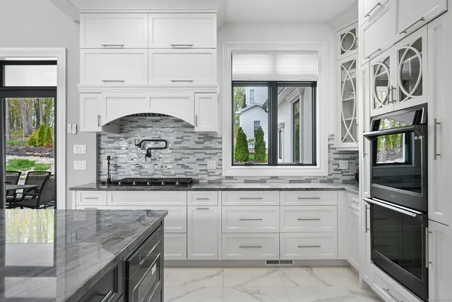 a kitchen with granite countertop a stove and a sink