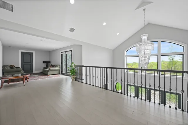 a view of a livingroom with furniture wooden floor and a window