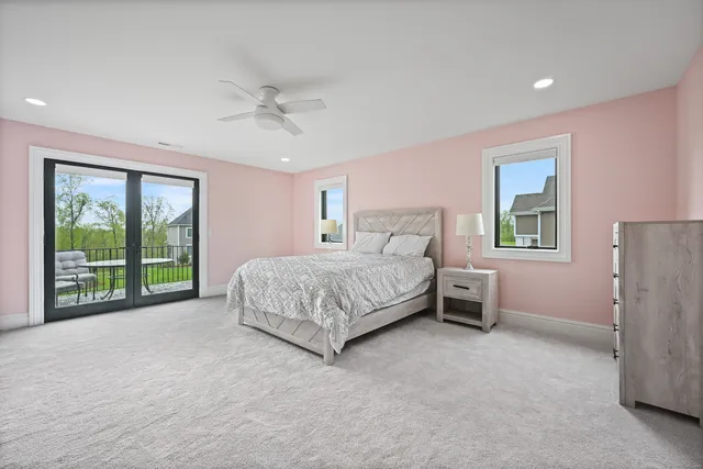 a bedroom with a bed and a dresser next to a window