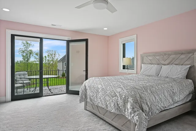 a bedroom with a large bed and a large window