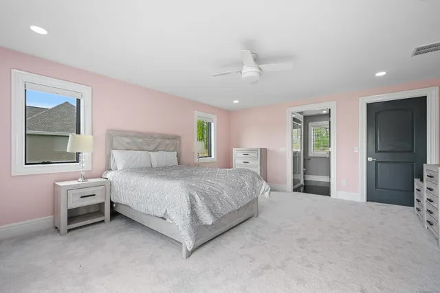 a spacious bedroom with a bed and a cabinets