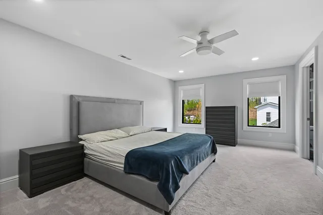 a spacious bedroom with a bed and window