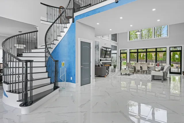 a view of a livingroom with furniture and staircase