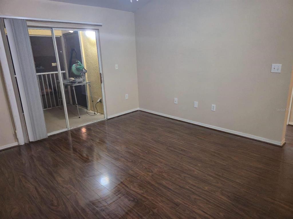 5459 Vineland Road, Unit 4310 Orlando, FL 32811 - Photo 11 of 12 an empty room with wooden floor and entrance