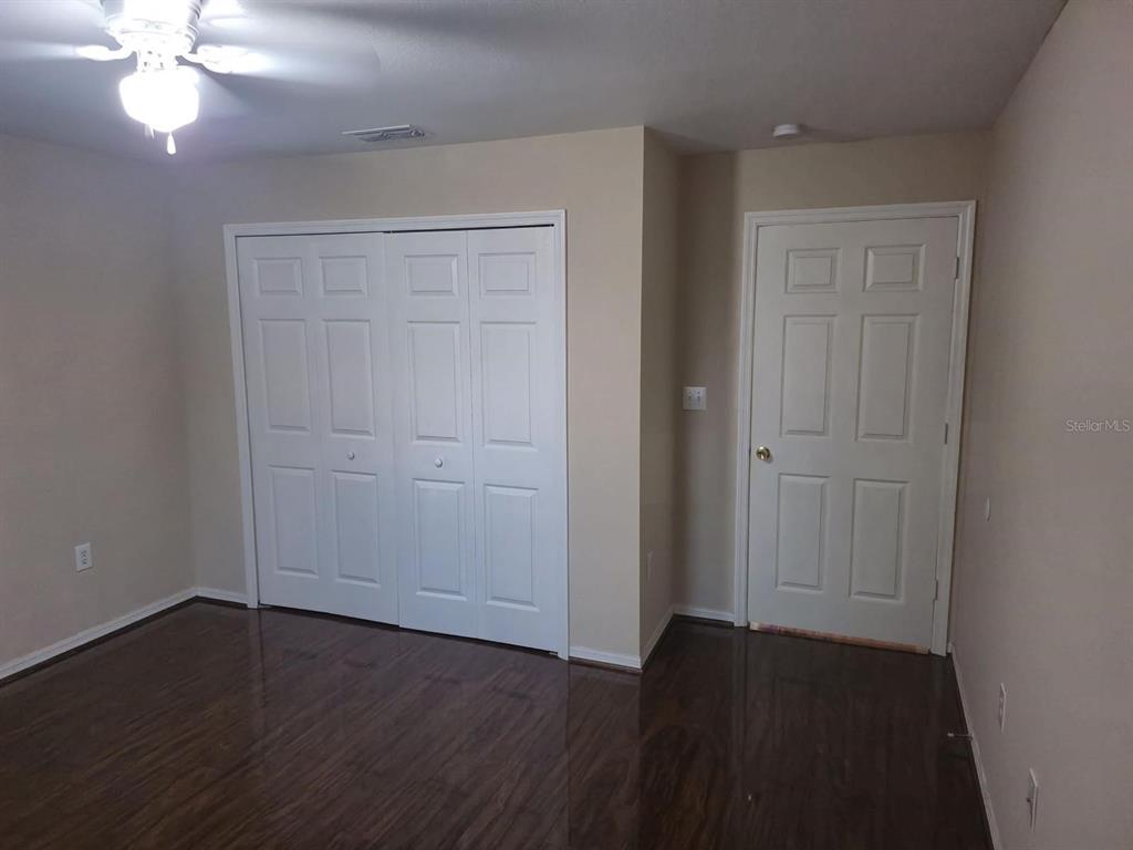 5459 Vineland Road, Unit 4310 Orlando, FL 32811 - Photo 7 of 12 wooden floor in an empty room