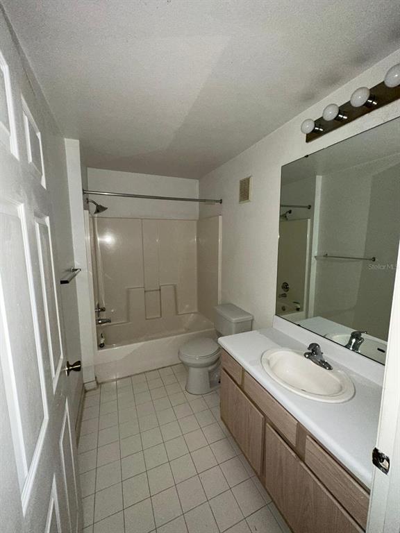 5459 Vineland Road, Unit 4310 Orlando, FL 32811 - Photo 9 of 12 a bathroom with a sink a toilet a mirror and shower