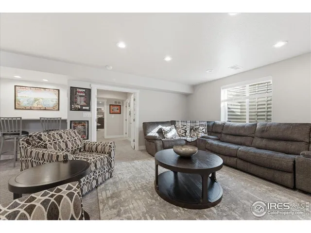 a living room with furniture a window and a table