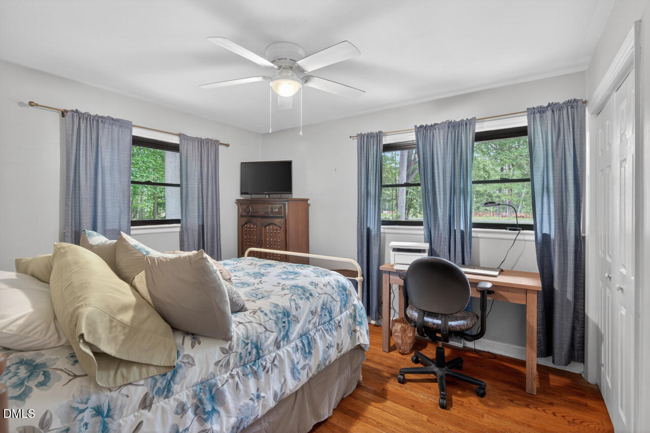 1420 Goodwin Road Durham, NC 27712 - Photo 23 of 54 a bedroom with a bed and wooden floor