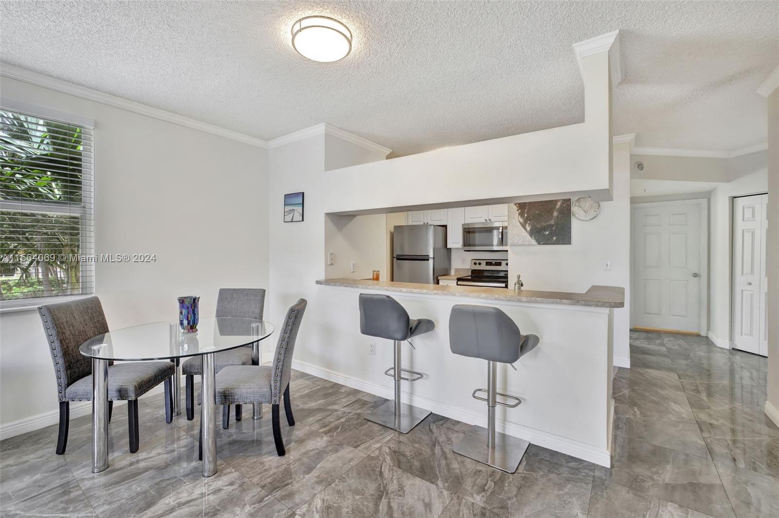 17150 North Bay Road, Unit 2216 Sunny Isles Beach, FL 33160 - Photo 12 of 46 a dining room with furniture and window