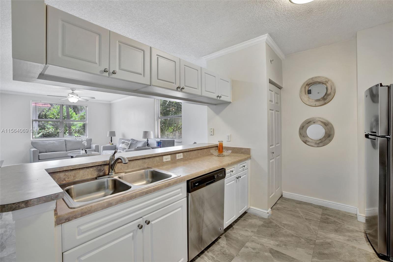 17150 North Bay Road, Unit 2216 Sunny Isles Beach, FL 33160 - Photo 14 of 46 a kitchen with a sink and cabinets